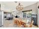 Open floorplan with view of dining room and kitchen features a modern light fixture and backyard views at 6324 Brevada Ln, Apollo Beach, FL 33572