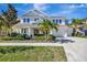 Beautiful two-story home with a well-manicured lawn, lush landscaping, and a three car garage at 6324 Brevada Ln, Apollo Beach, FL 33572
