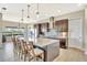 Bright kitchen features an island with bar stool seating, granite countertops and stainless steel appliances at 6324 Brevada Ln, Apollo Beach, FL 33572