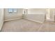 Bright loft area featuring neutral paint, carpeting, and plenty of natural light from two large windows at 6324 Brevada Ln, Apollo Beach, FL 33572