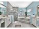 Main bathroom with double vanity, soaking tub, and glass-enclosed shower at 6324 Brevada Ln, Apollo Beach, FL 33572