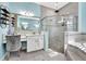 Main bathroom featuring a make up vanity, glass-enclosed shower, and modern decor at 6324 Brevada Ln, Apollo Beach, FL 33572