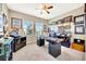 Home office with ceiling fan, carpeting, natural light from two large windows, and dark wood furnishings at 6324 Brevada Ln, Apollo Beach, FL 33572