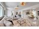 Spacious living room with terrazzo floors, modern lighting, and an open layout leading to the dining area at 6632 23Rd S St, St Petersburg, FL 33712