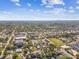 Wide aerial view showcasing the city skyline and neighborhood with lush green trees at 6680 67Th N Way, Pinellas Park, FL 33781