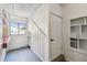 Wet bar area with red tile counter and built in shelves adjacent to a door and staircase at 6680 67Th N Way, Pinellas Park, FL 33781