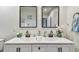 Well-lit bathroom featuring dual sinks, framed mirrors, and stylish decor at 6680 67Th N Way, Pinellas Park, FL 33781