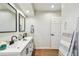 Well-lit bathroom featuring dual sinks, framed mirrors, and a decorative ladder at 6680 67Th N Way, Pinellas Park, FL 33781