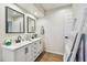 Bright bathroom featuring a double vanity, framed mirrors, and modern fixtures at 6680 67Th N Way, Pinellas Park, FL 33781