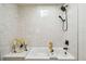 Beautiful white tiled tub and shower area with modern fixtures at 6680 67Th N Way, Pinellas Park, FL 33781