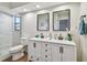 Modern bathroom featuring double sinks, framed mirrors, and walk-in glass shower at 6680 67Th N Way, Pinellas Park, FL 33781