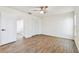 Spacious bedroom with wood-look flooring, large closet, and a modern ceiling fan at 6680 67Th N Way, Pinellas Park, FL 33781