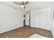 Spacious bedroom offers modern flooring, a fan, and a closet with a doorway to the bath at 6680 67Th N Way, Pinellas Park, FL 33781