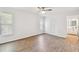 Sunlit bedroom featuring wood-look flooring, a ceiling fan, and closet at 6680 67Th N Way, Pinellas Park, FL 33781