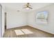 A lovely bedroom features a ceiling fan, wood-look floors, and windows providing natural light at 6680 67Th N Way, Pinellas Park, FL 33781