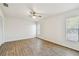 Bright bedroom featuring hardwood floors, a ceiling fan, and two windows for natural light at 6680 67Th N Way, Pinellas Park, FL 33781
