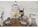 Dining area with wood table, modern chandelier, and open view to the living spaces at 6680 67Th N Way, Pinellas Park, FL 33781