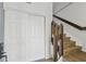 Entryway with light wood stairs and floors, featuring coat closet and stairway access at 6680 67Th N Way, Pinellas Park, FL 33781