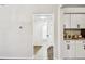 Hallway view into updated bathroom and kitchen at 6680 67Th N Way, Pinellas Park, FL 33781