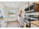 A beautifully remodeled kitchen showcasing stainless steel appliances, granite countertops, and subway tile backsplash at 6680 67Th N Way, Pinellas Park, FL 33781