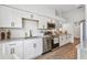 Updated kitchen features granite counters, stainless appliances, and white cabinetry for a clean aesthetic at 6680 67Th N Way, Pinellas Park, FL 33781