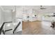 Open floor plan with hardwood floors, modern chandelier, ceiling fan and white walls at 6680 67Th N Way, Pinellas Park, FL 33781