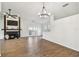 Open floor plan featuring hardwood floors, modern chandelier, fireplace, white walls and french doors at 6680 67Th N Way, Pinellas Park, FL 33781