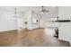 Open floor plan with hardwood floors, modern chandelier, ceiling fan and white walls at 6680 67Th N Way, Pinellas Park, FL 33781
