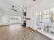 Open floor plan featuring hardwood floors, fireplace, white walls and french doors at 6680 67Th N Way, Pinellas Park, FL 33781