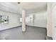 Spacious living room featuring modern gray flooring, bright white walls, and large windows at 6680 67Th N Way, Pinellas Park, FL 33781