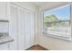 Well-lit pantry features white bi-fold doors and exterior view from nearby window at 6680 67Th N Way, Pinellas Park, FL 33781