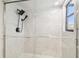 Modern shower featuring white marble tile, glass doors, and rainfall shower head at 6680 67Th N Way, Pinellas Park, FL 33781