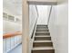 Staircase leads to an area with built in shelving and a wood topped bench at 6680 67Th N Way, Pinellas Park, FL 33781