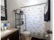 Cozy bathroom featuring a shower with dinosaur-themed curtain and granite countertops at 724 Tradewinds Dr, Brandon, FL 33511