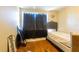 Bedroom features hardwood floors, neutral walls and a window with dark curtains at 724 Tradewinds Dr, Brandon, FL 33511