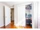 Bedroom closet with wood floors, an open closet door, and laundry appliances in the background at 724 Tradewinds Dr, Brandon, FL 33511