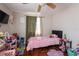 Bright bedroom with hardwood floors, ceiling fan, and a large window allowing natural light at 724 Tradewinds Dr, Brandon, FL 33511