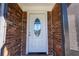 Close-up of an elegant white front door featuring a decorative oval glass insert at 724 Tradewinds Dr, Brandon, FL 33511