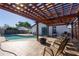 Inviting backyard featuring a refreshing pool, relaxing pergola, and a cozy seating area for outdoor enjoyment at 724 Tradewinds Dr, Brandon, FL 33511