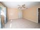 Bedroom with tile flooring, ceiling fan, and gray drapes at 7307 Star Dust Dr, Port Richey, FL 34668