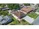 Aerial view of the property showcasing the roof, lawn and surrounding neighborhood at 8210 Marigold Ave, Tampa, FL 33614