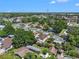 Expansive aerial view of a neighborhood with mature trees and well-maintained homes on a sunny day at 8210 Marigold Ave, Tampa, FL 33614