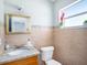 Elegant bathroom with granite countertop, decorative mirror, and a window for natural light at 8210 Marigold Ave, Tampa, FL 33614