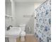 Bathroom with pedestal sink and shower with unique shell-themed shower curtain at 8210 Marigold Ave, Tampa, FL 33614