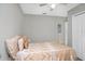 Cozy bedroom with a ceiling fan and a bed with decorative pillows and gold accents at 8210 Marigold Ave, Tampa, FL 33614