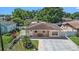 Charming single-story home with a well-manicured lawn, freshly painted exterior, and inviting front porch at 8210 Marigold Ave, Tampa, FL 33614
