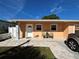 Charming single-story home featuring a cozy front porch and well-maintained lawn with a brick walkway at 8210 Marigold Ave, Tampa, FL 33614