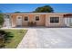 Charming single-story home featuring a cozy front porch and well-maintained lawn and brick walkway at 8210 Marigold Ave, Tampa, FL 33614