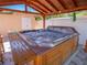 Luxurious hot tub area under a covered wooden structure for relaxation and entertainment at 8210 Marigold Ave, Tampa, FL 33614