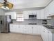 Bright kitchen featuring white cabinets, stainless steel appliances, and neutral countertops at 8210 Marigold Ave, Tampa, FL 33614